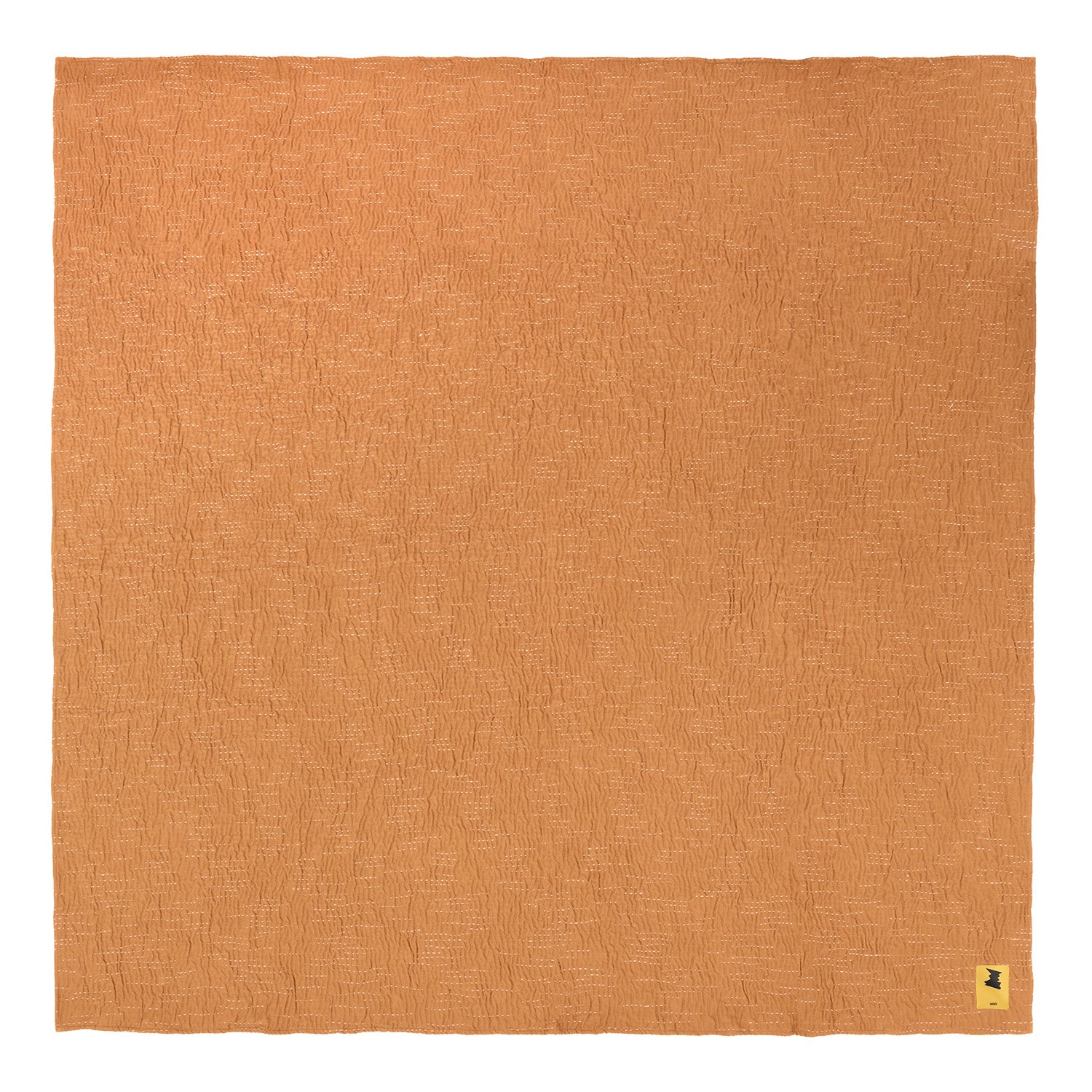 Brown cotton blanket swatch with a brand label in the corner