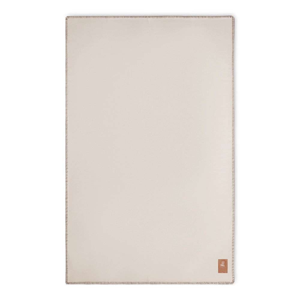 Beige merino blanket with a brand logo on a white background