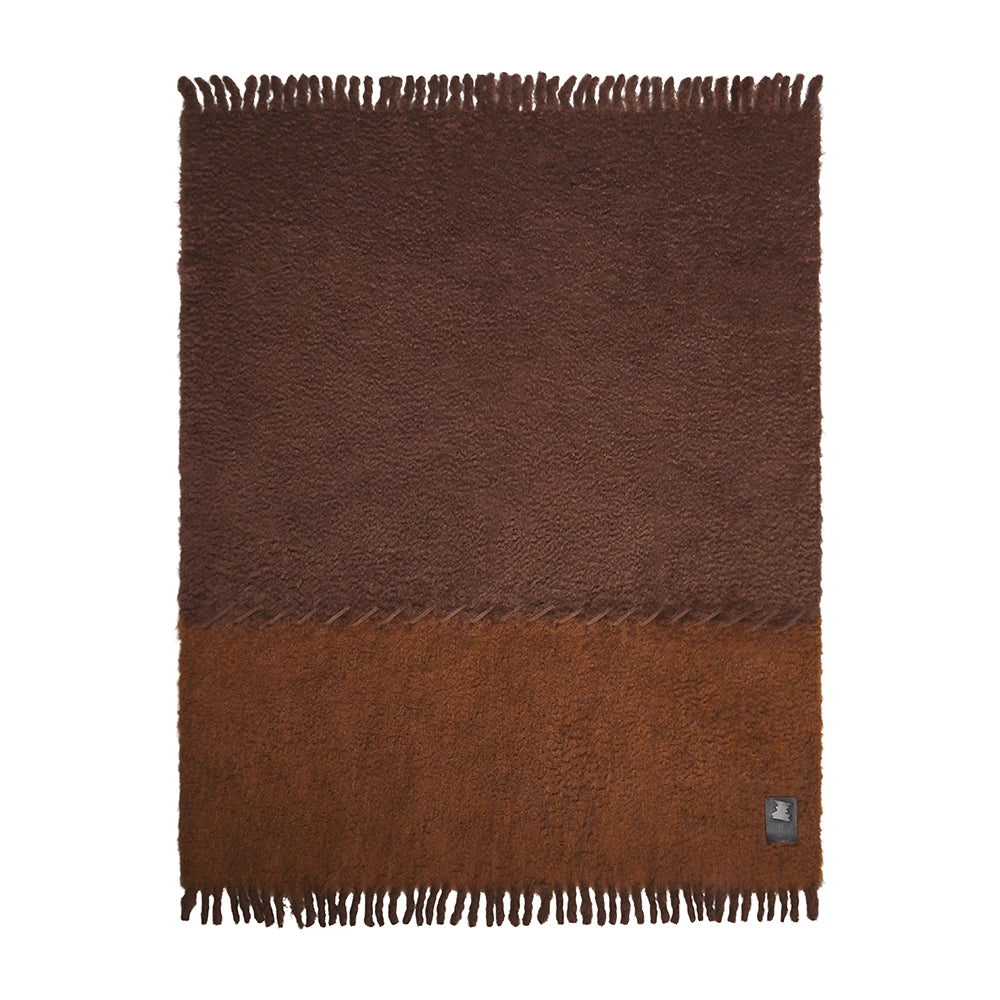 Brown mohair blanket with fringed edges on a white background