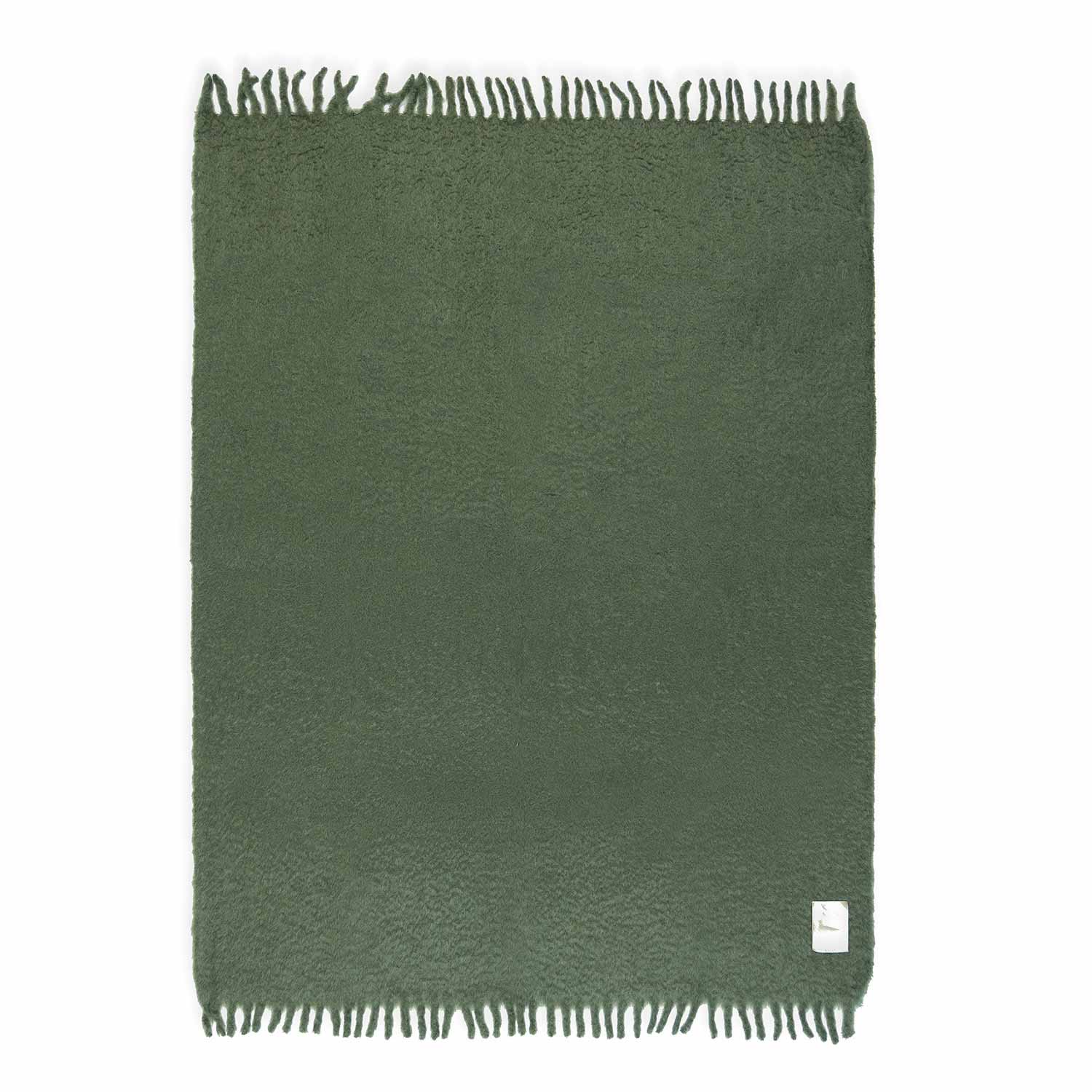 Flat green mohair blanket, featuring a fringe and a green leather label on one corner.