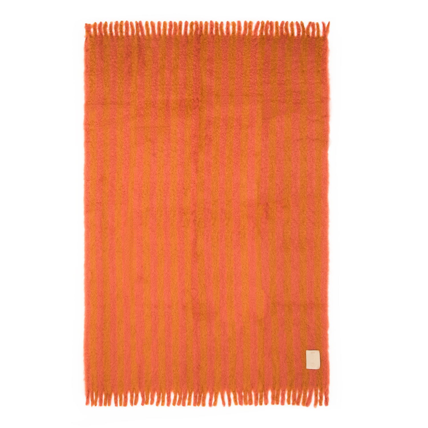 Folded mohair blanket with pink and orange stripes and a beige fringe, featuring a custom beige leather label on the lower right corner.