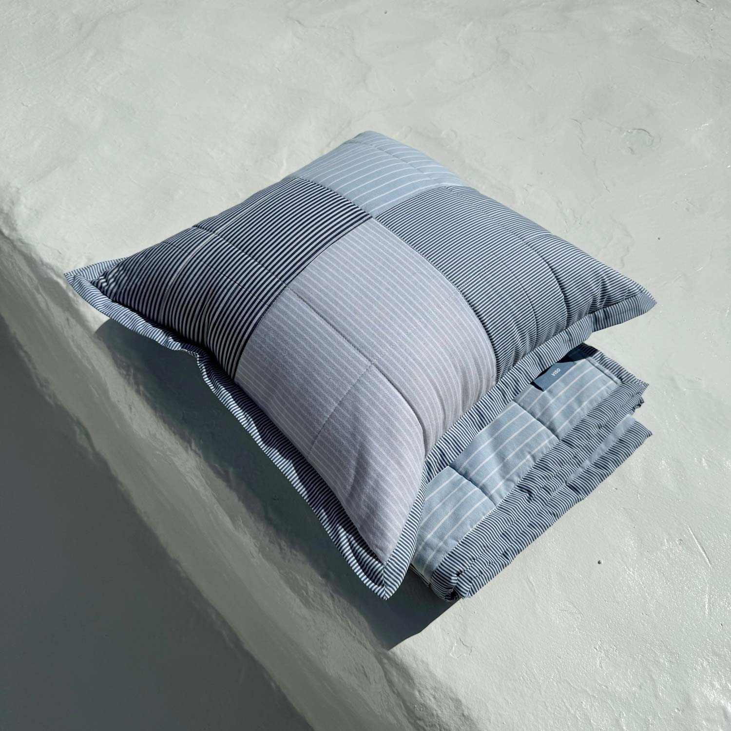Folded striped fabric on a textured surface