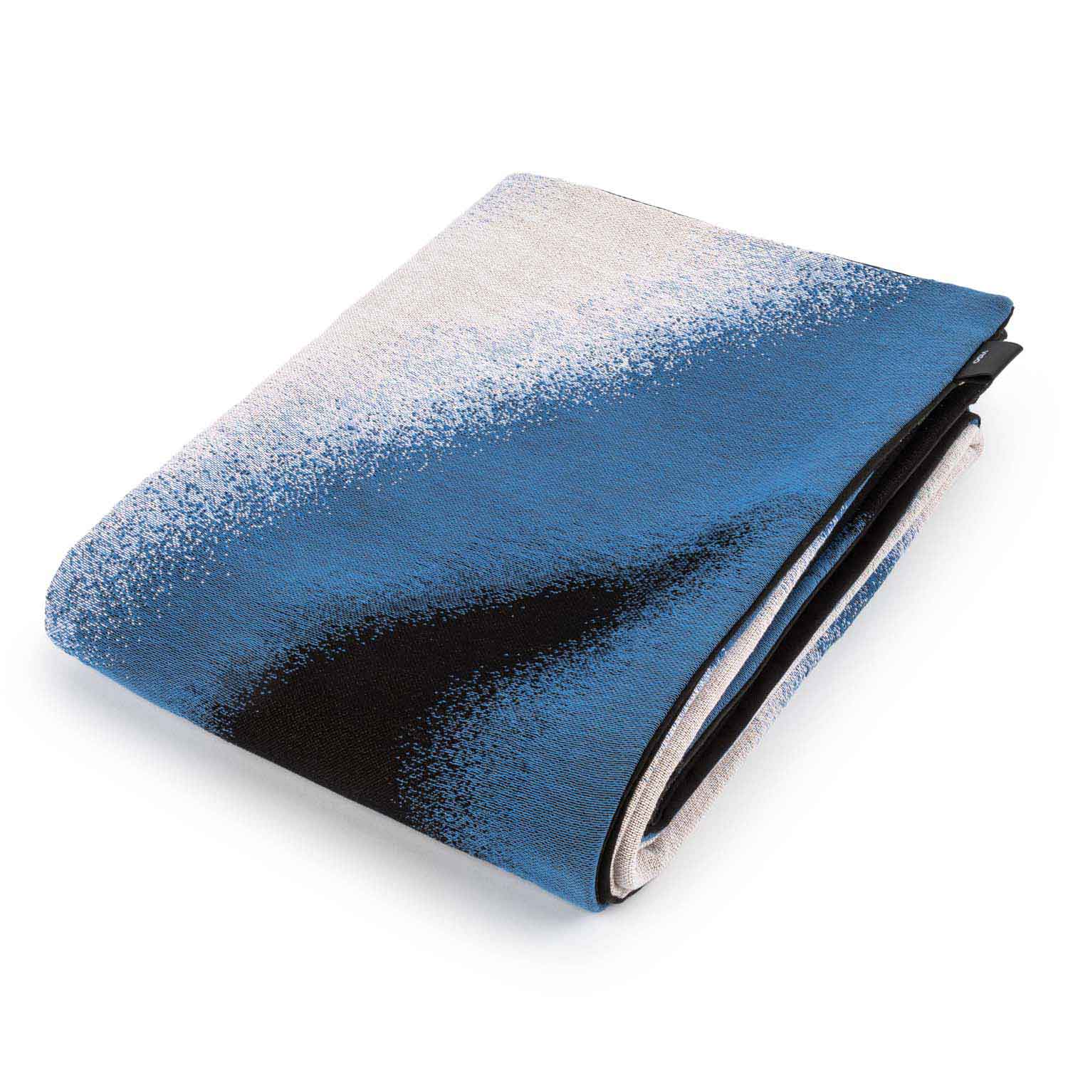 A folded tapestry blanket featuring an abstract design with prominent green, blue, black, and white colors.