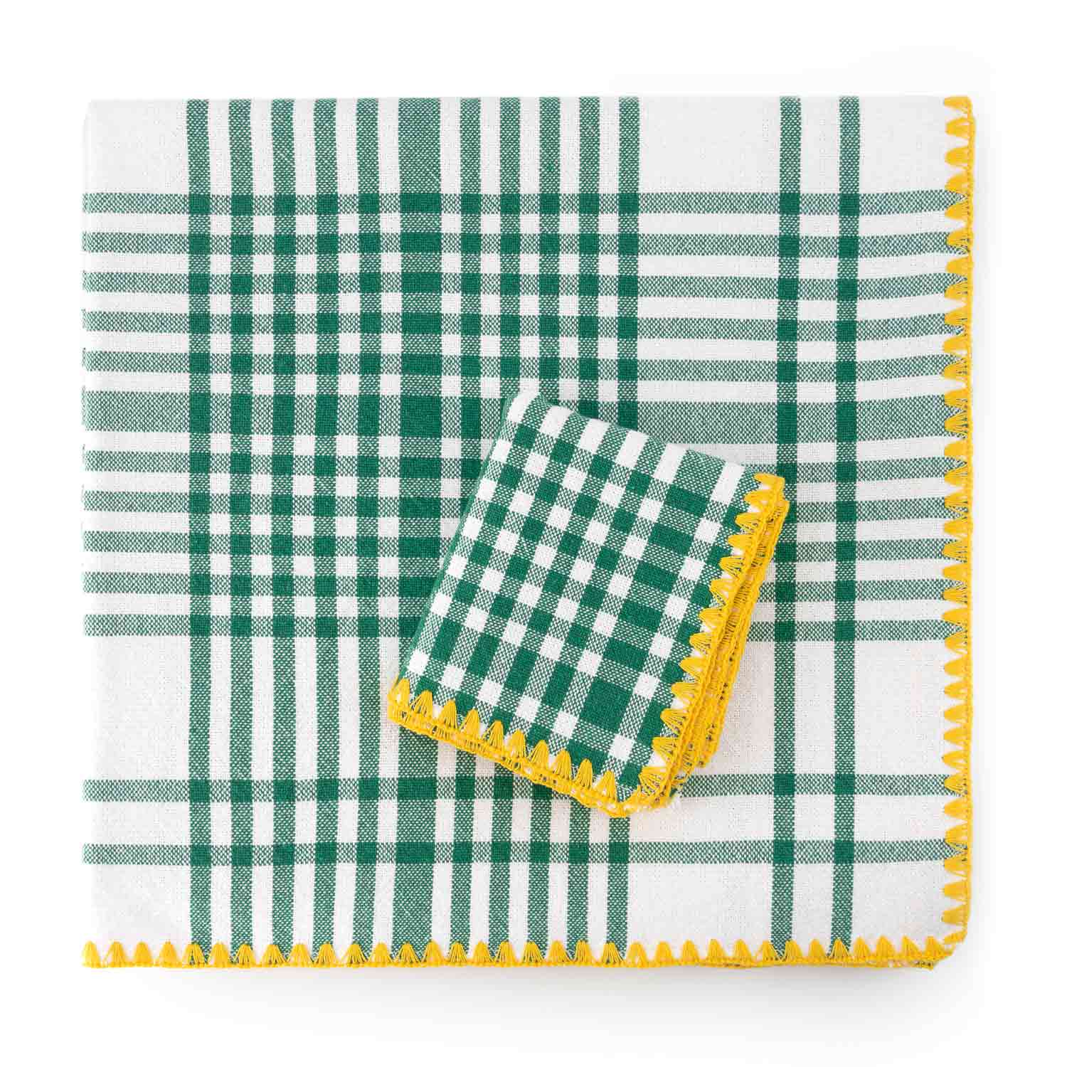 A folded cotton check jacquard tablecloth and napkin featuring a green and yellow plaid pattern with contrasting detail stitching.