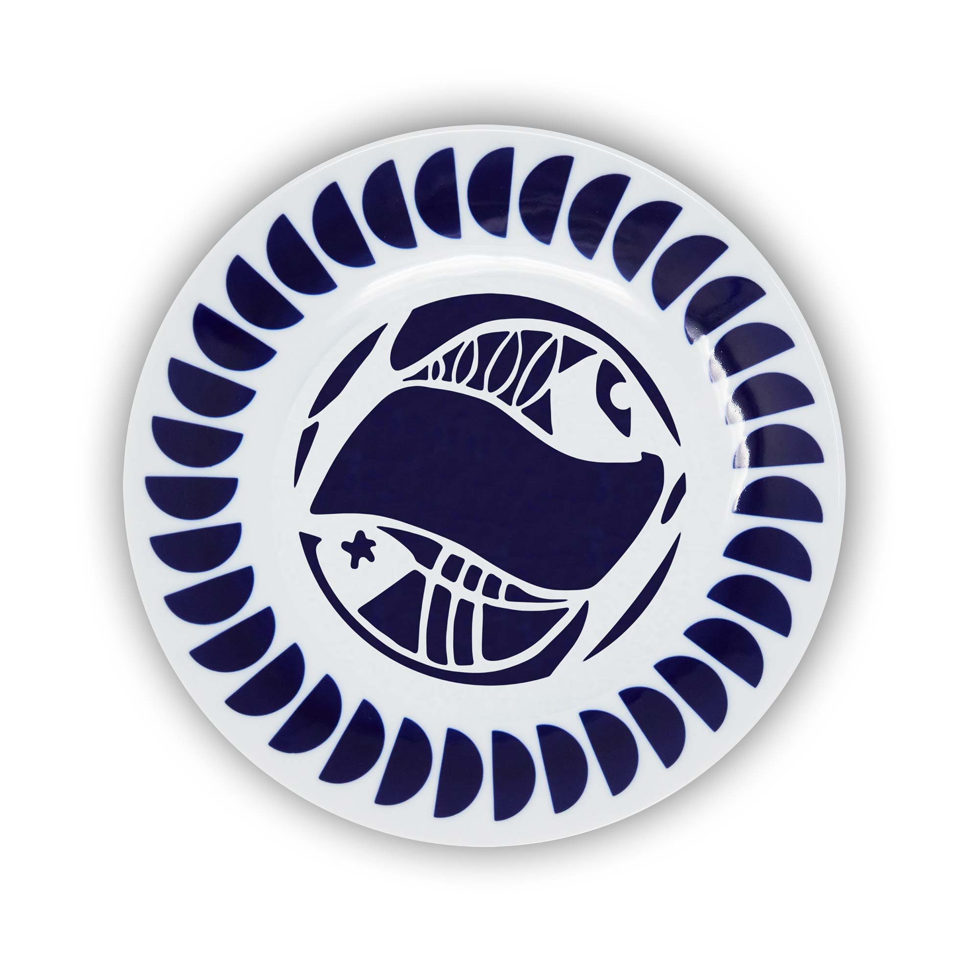 A round porcelain plate with a navy and white design featuring an illustration of the Pisces sign of the zodiac.
