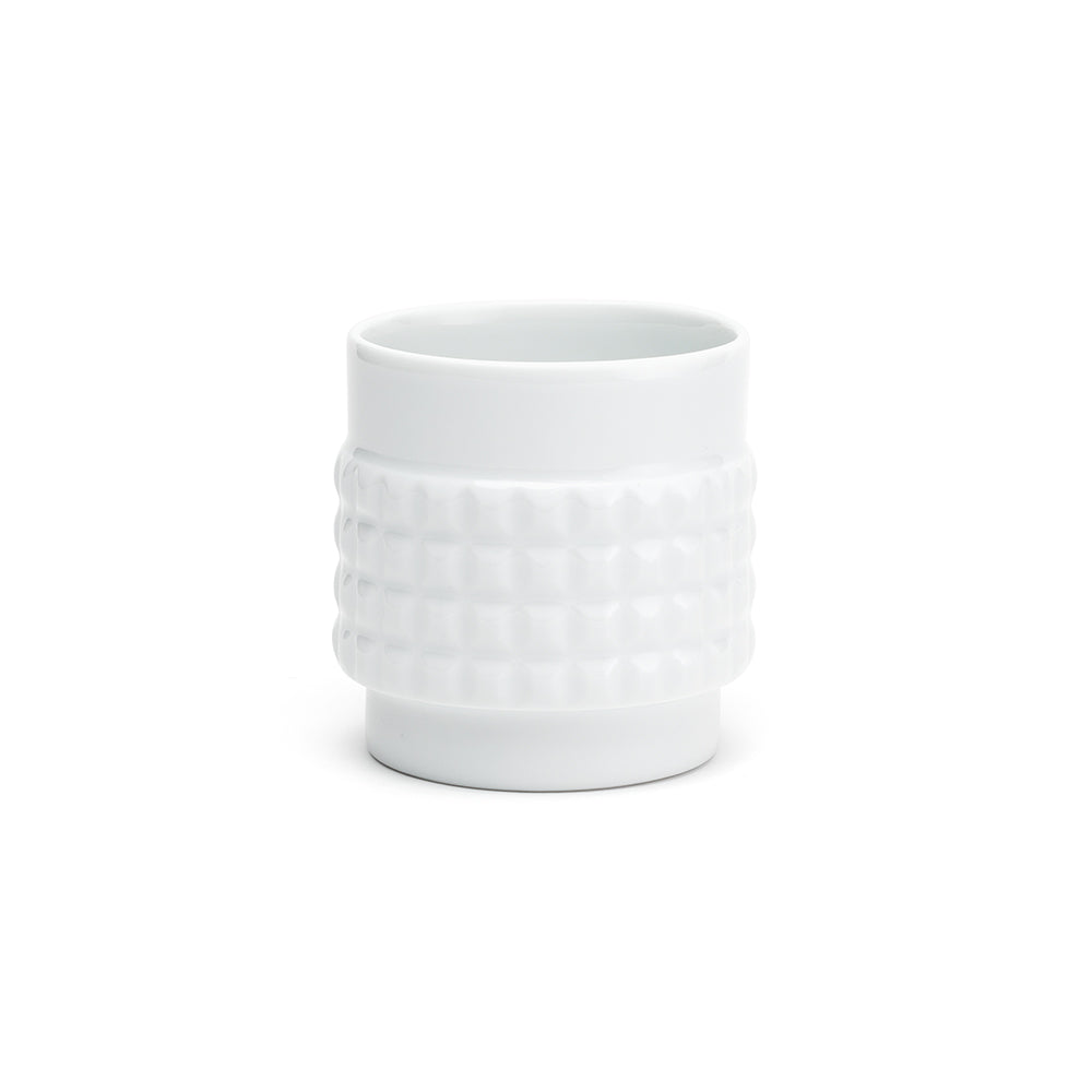 A white porcelain cup with a shape reminiscent of the various forms of nuts.
