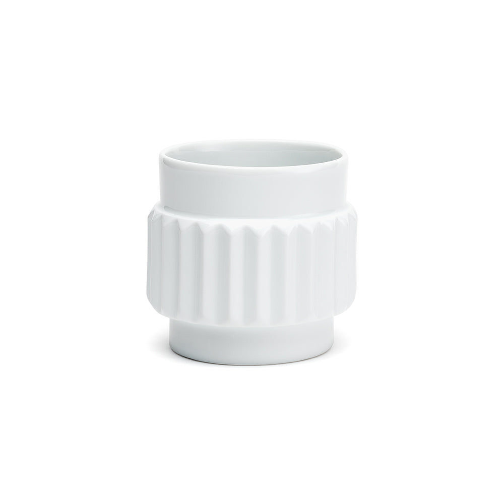 A white porcelain cup with a shape reminiscent of the various forms of nuts.