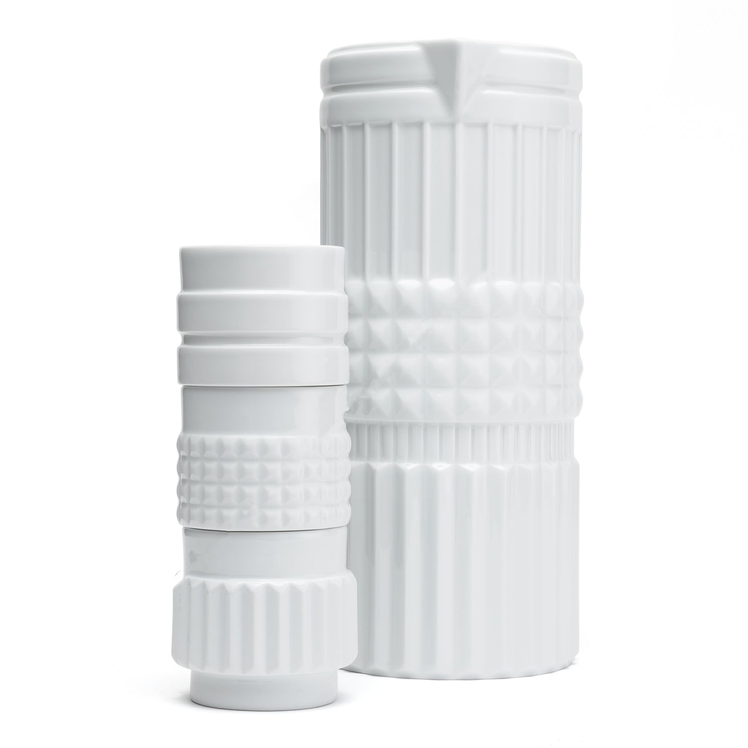 A white porcelain vase and cups with a shape reminiscent of the various forms of nuts.