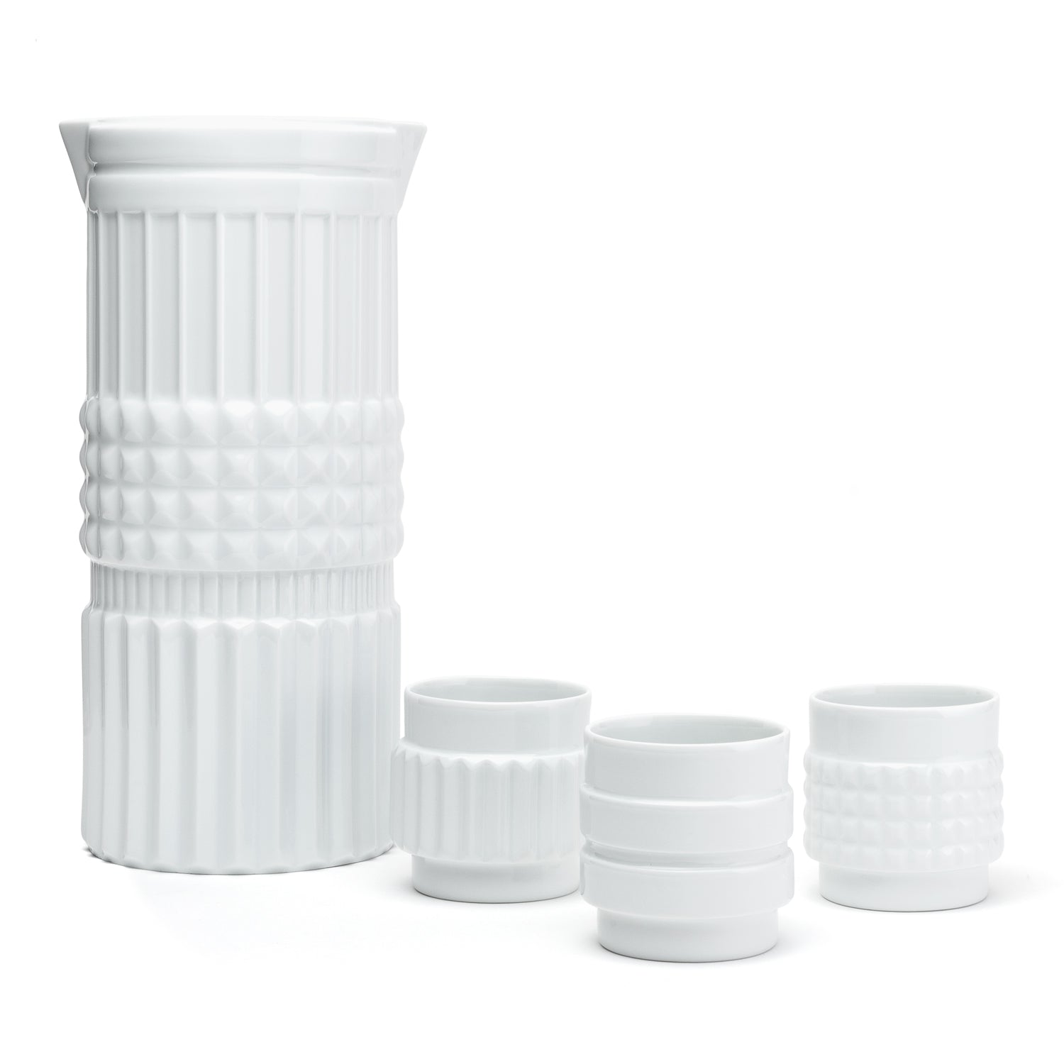 A white porcelain vase and cups with a shape reminiscent of the various forms of nuts.