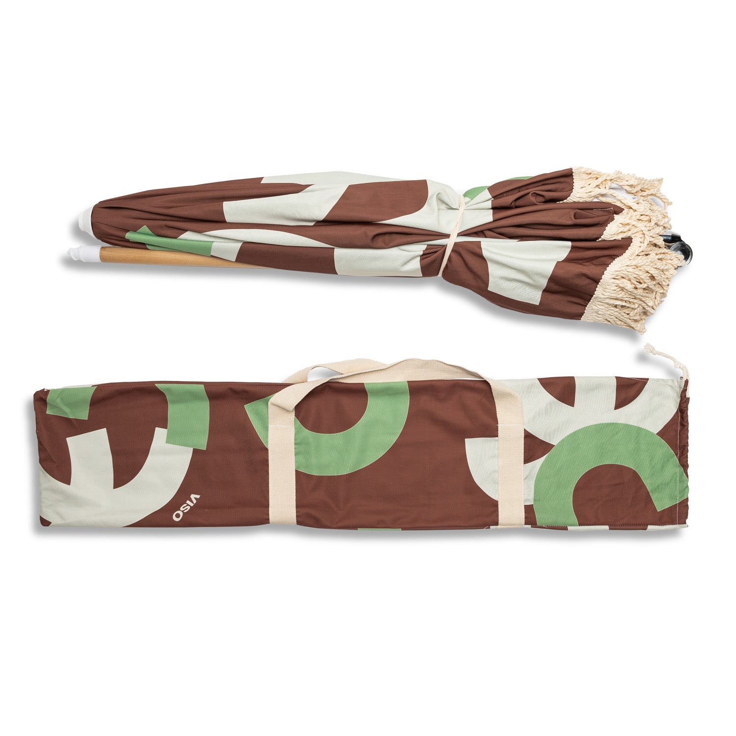 A brown and grenn beach umbrella, folded up and placed next to the canvas bag in which it can be stored