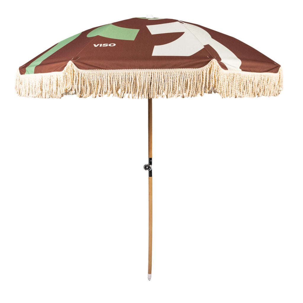 A brown umbrella with a green and white pattern on the canopy and a wooden handle.