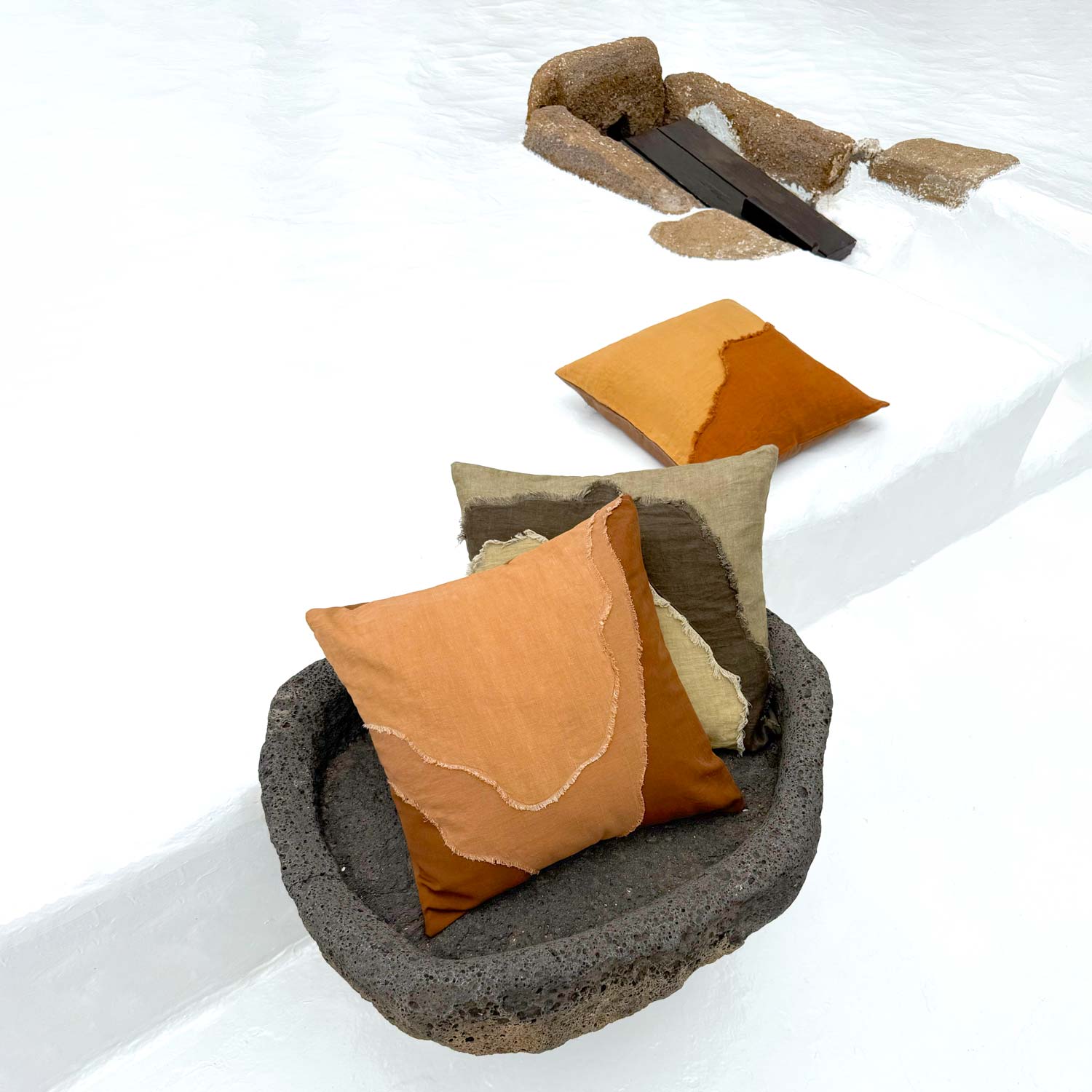 Decorative pillows in brown and beige on a textured surface