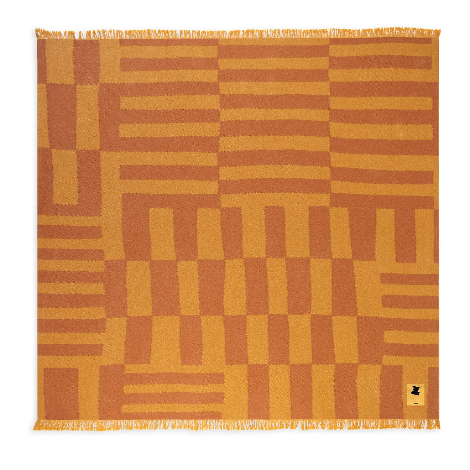 Patterned beach towel with geometric design in orange and brown on a white background