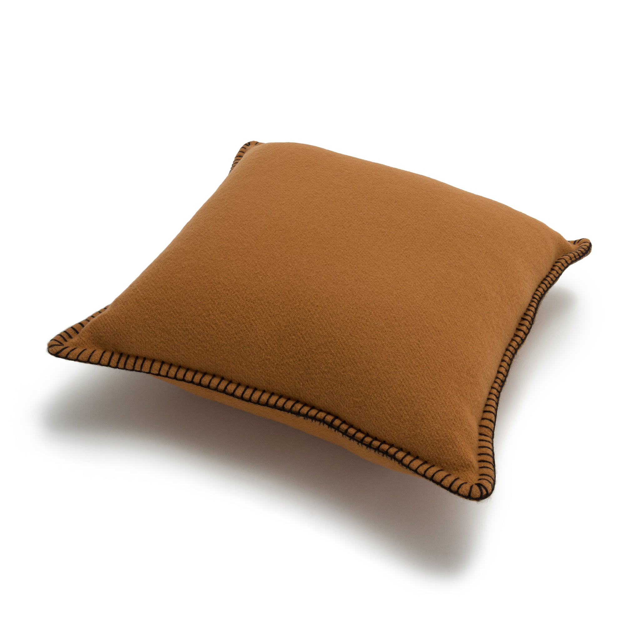 A square-shaped pillow with a camel color and black decorative stitching on the edges.
