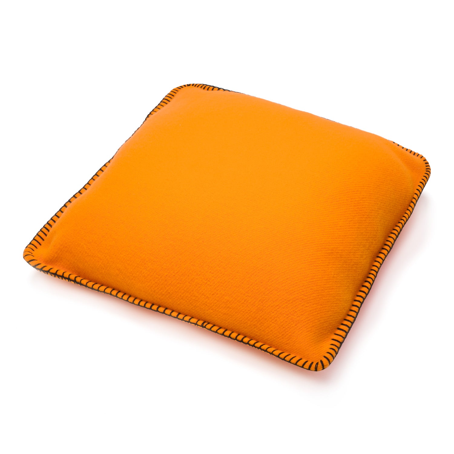 An orange square merino wool pillow with black and orange stitched edges on a white background.