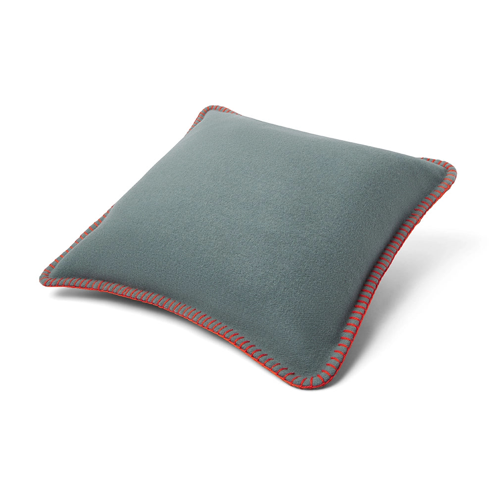 Gray cushion with red stitching on a white background