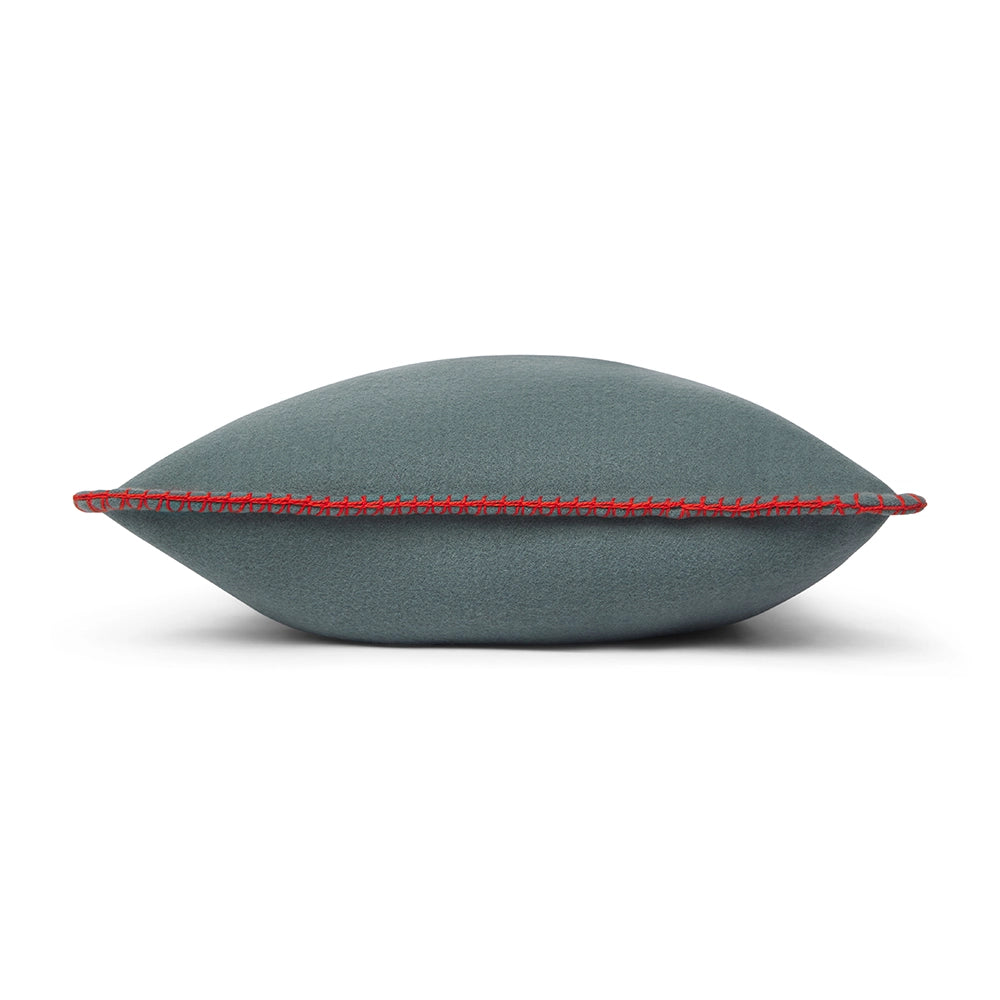 Gray cushion with red stitching on a white background