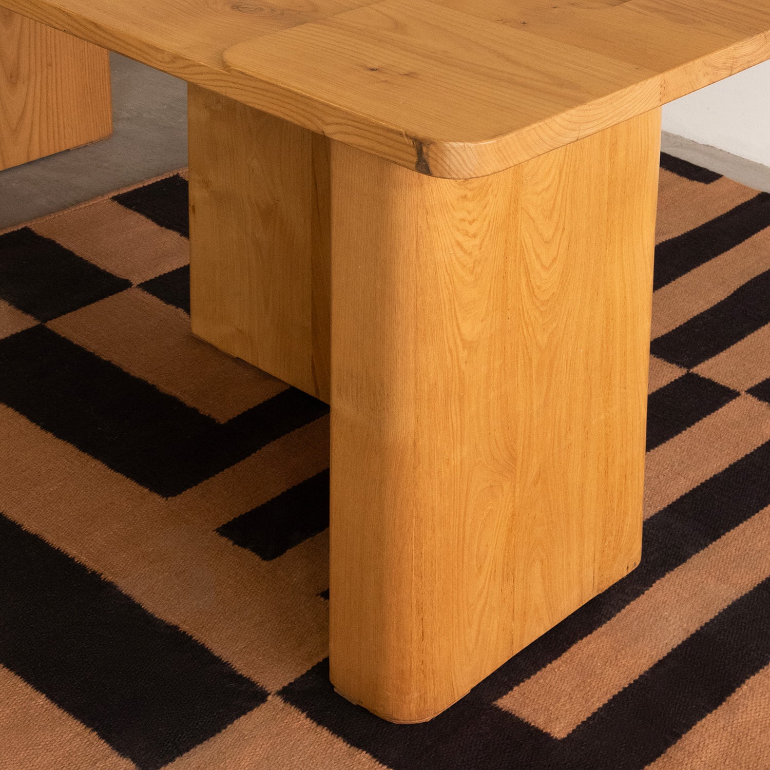 Wooden table on a checkered floor